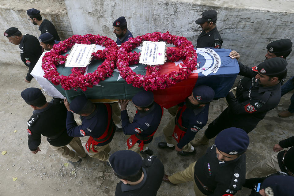 A police contingent carries the casket of a police officer, a victim of Monday's suicide bombing, during his funeral in Peshawar, Pakistan, Feb. 2, 2023. A suicide bomber who killed 101 people at a mosque in northwest Pakistan this week had disguised himself in a police uniform and did not raise suspicion among guards, the provincial police chief said on Thursday. (AP Photo/Muhammad Sajjad)