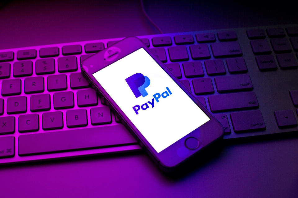 SPAIN - 2021/10/13: In this photo illustration a PayPal Holdings, Inc. logo seen displayed on a smartphone on top of a computer keyboard. (Photo Illustration by Thiago Prudencio/SOPA Images/LightRocket via Getty Images)