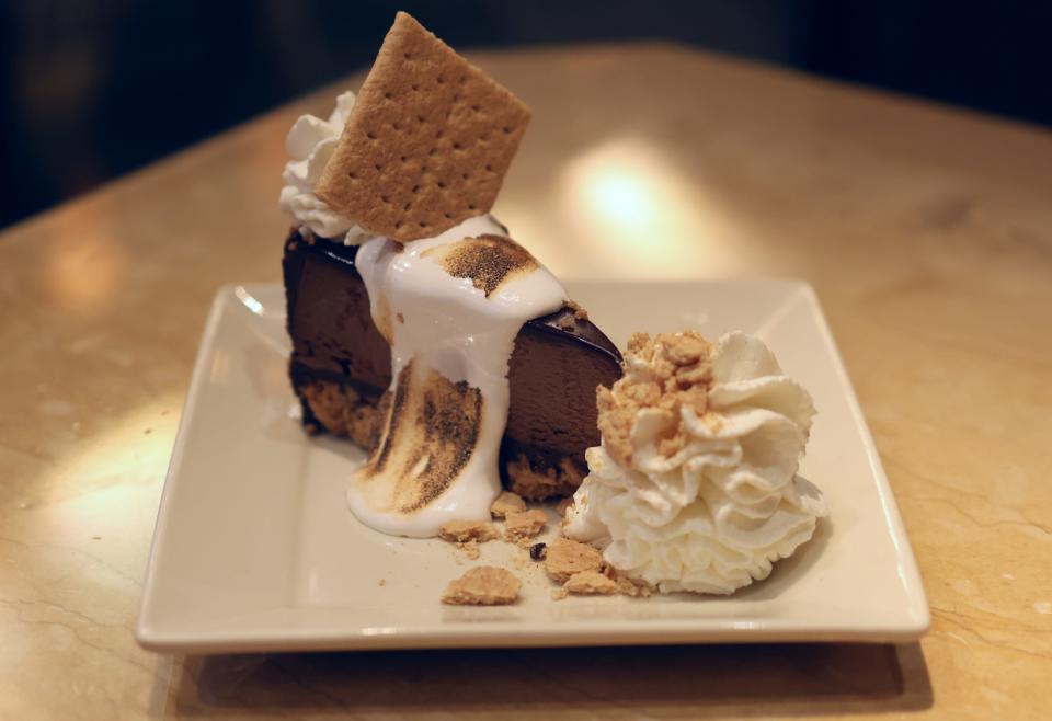 A slice of the Toasted Marshmallow S'mores Galore cheesecake at The Cheesecake Factory.