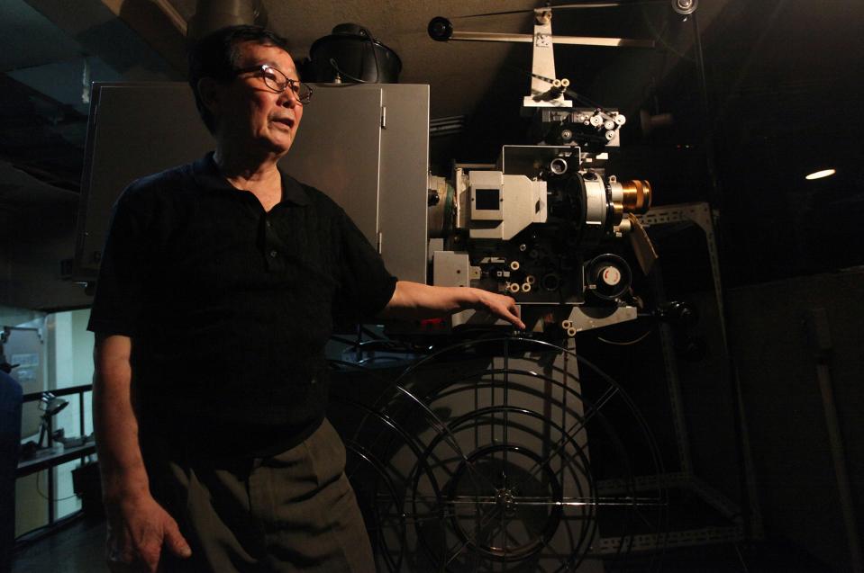 Lee Gil-ung, projectionist at Seoul's last old-style one-screen cinema, poses for a portrait inside the projection room at Seodaemun Art Hall in Seoul, South Korea, Wednesday, July 11, 2012. Seoul's last old-style one-screen cinema, soon to be knocked down and replaced by a new tourist hotel, played its final movie Wednesday - the Italian classic "The Bicycle Thief." (AP Photo/Hye Soo Nah)