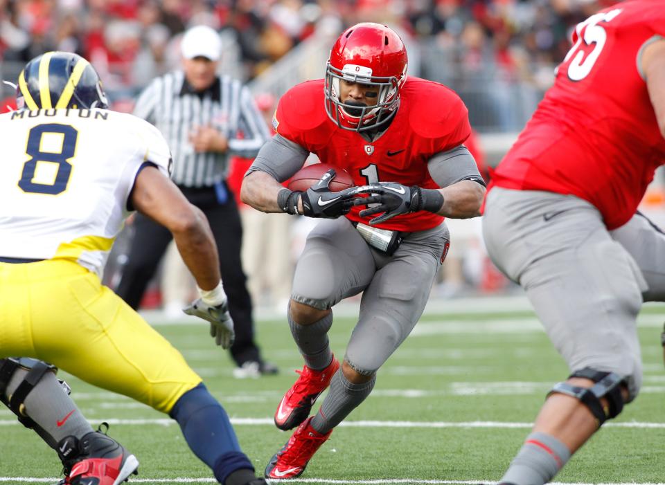 Ohio State Buckeyes running back Dan Herron (1) runs against the Michigan Wolverines defense in the second half of their NCAA football game at the Ohio Stadium, Novemver 27, 2010. (Dispatch photo by Neal C. Lauron)