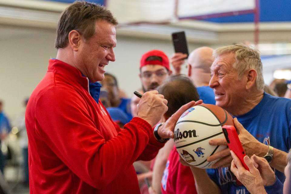 Kansas coach Bill Self stops to talk with as many fans as he can and sign objects the day after his Jayhawks staged a record comeback to win the NCAA men's basketball championship.