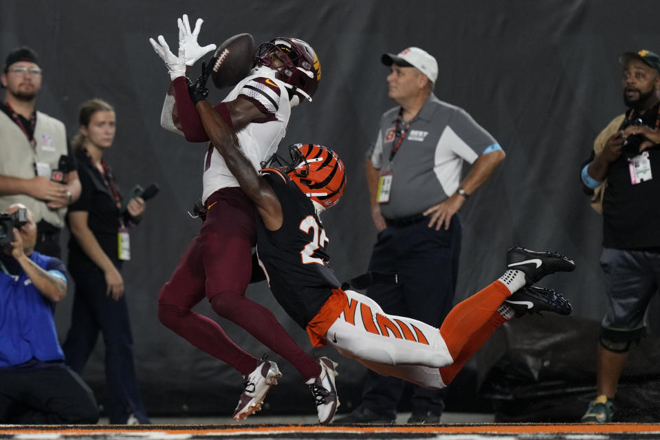 Washington Commanders wide receiver Terry McLaurin, left, catches a 27-yard touchdown pass ahead of Cincinnati Bengals cornerback Dax Hill during the second half of an NFL football game, Monday, Sept. 23, 2024, in Cincinnati. (AP Photo/Carolyn Kaster)