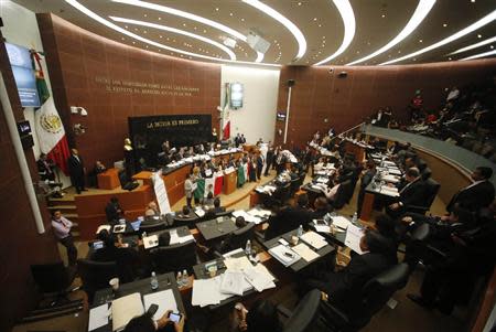 Senators of the Party of the Democratic Revolution (PRD) interrupt a debate on an energy reform bill at the Senate in Mexico City December 9, 2013. REUTERS/Henry Romero