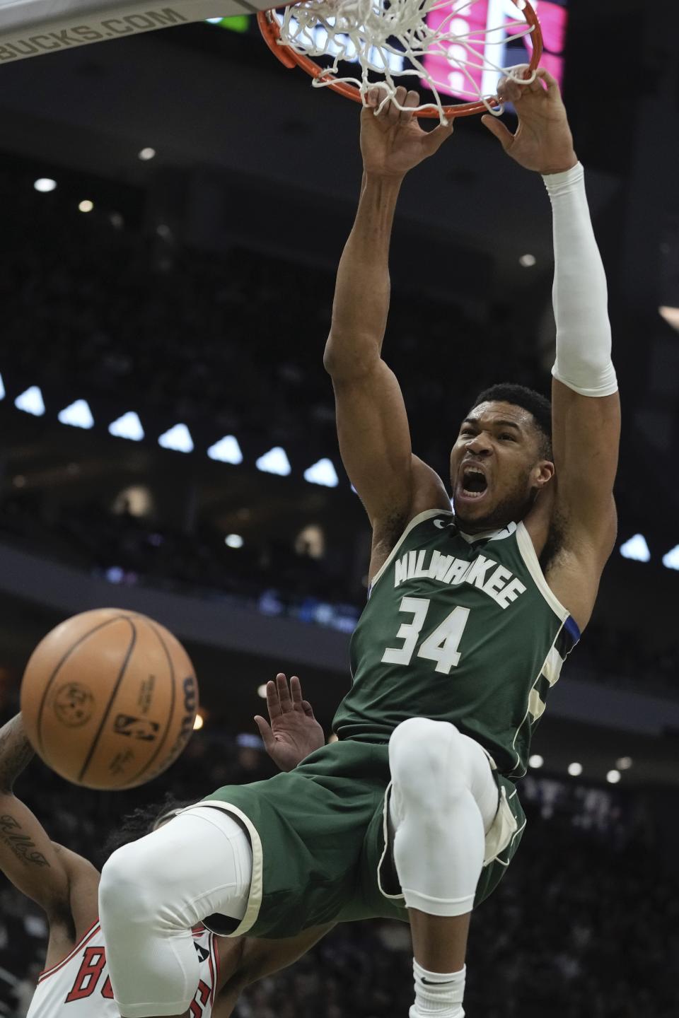 Milwaukee Bucks' Giannis Antetokounmpo dunks during the first half of an NBA basketball game Monday, Dec. 11, 2023, in Milwaukee. (AP Photo/Morry Gash)