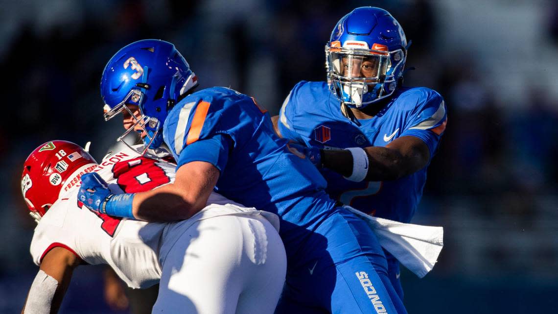 Boise State running back Ashton Jeanty follows a blocky by Boise State tight end Riley Smith on Fresno State defensive end Isaiah Johnson during the first half of the Mountain West Championship, Saturday, Dec. 3, 2022, at Albertsons Stadium in Boise.