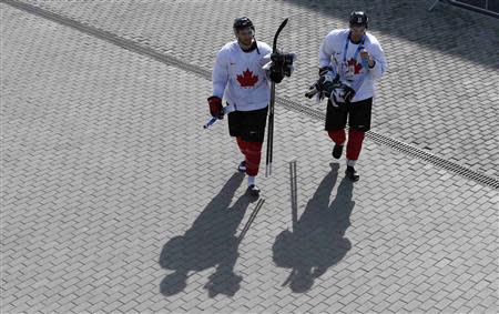 Canada's men's ice hockey team players Patrice Bergeron (L) and Jamie Benn walk back to the Bolshoy Arena after a team practice at the 2014 Sochi Winter Olympics, February 22, 2014. REUTERS/Jim Young