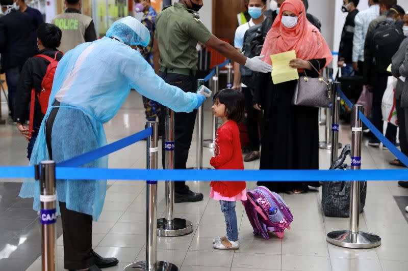 A child is being checked with thermal scanner at the Hazrat Shahjalal International Airport as a preventive measure against coronavirus in Dhaka