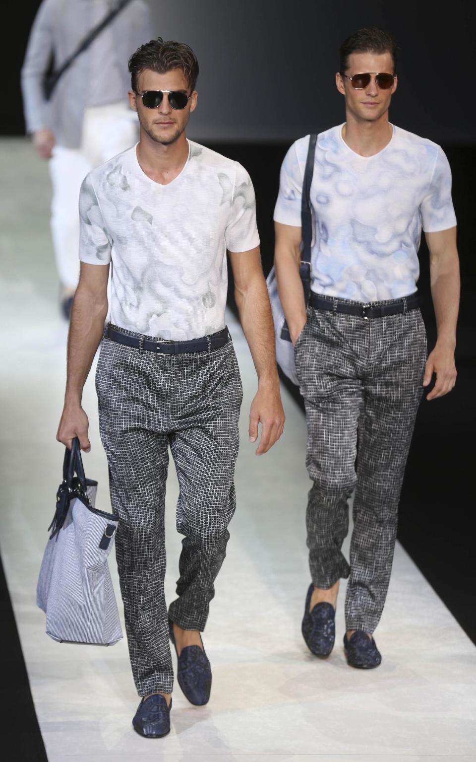 Models wear creations for Giorgio Armani men's Spring-Summer 2014 collection, part of the Milan Fashion Week, unveiled in Milan, Italy, Tuesday, June 25, 2013. (AP Photo/Luca Bruno)