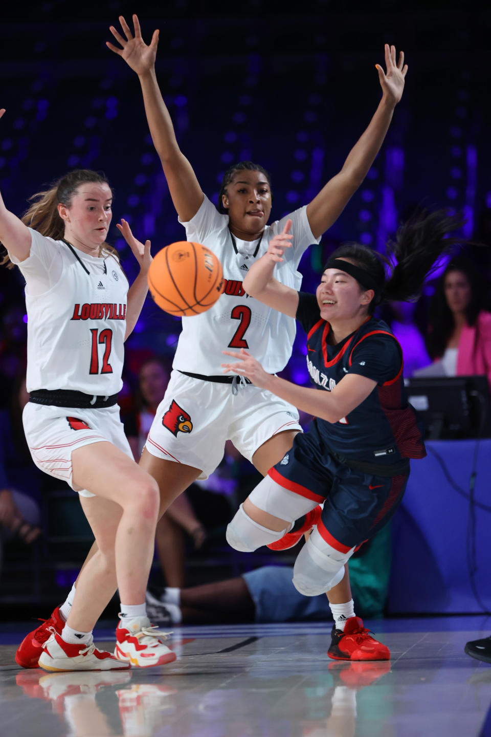 In a photo provided by Bahamas Visual Services, Gonzaga guard Kayleigh Truong, right, is defended by Louisville guard Payton Verhulst, left, and forward Nyla Harris during an NCAA college basketball game in the Battle 4 Atlantis at Paradise Island, Bahamas, Saturday, Nov. 19, 2022. (Tim Aylen/Bahamas Visual Services via AP)