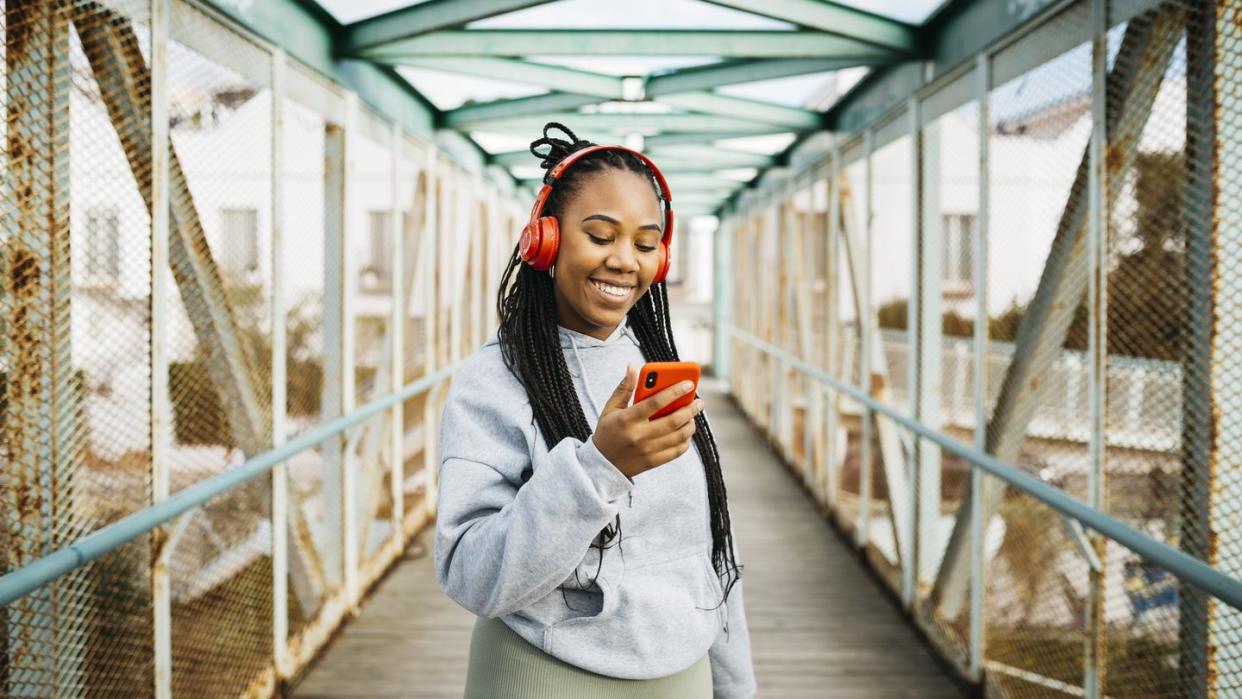 woman using a smartphone and headphones