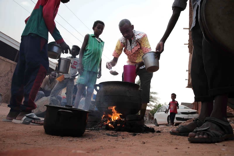 People prepare food in a Khartoum neighborhood on June 16, 2023. Sudan has been torn by war for a year now, torn by fighting between the military and the notorious paramilitary Rapid Support Forces.