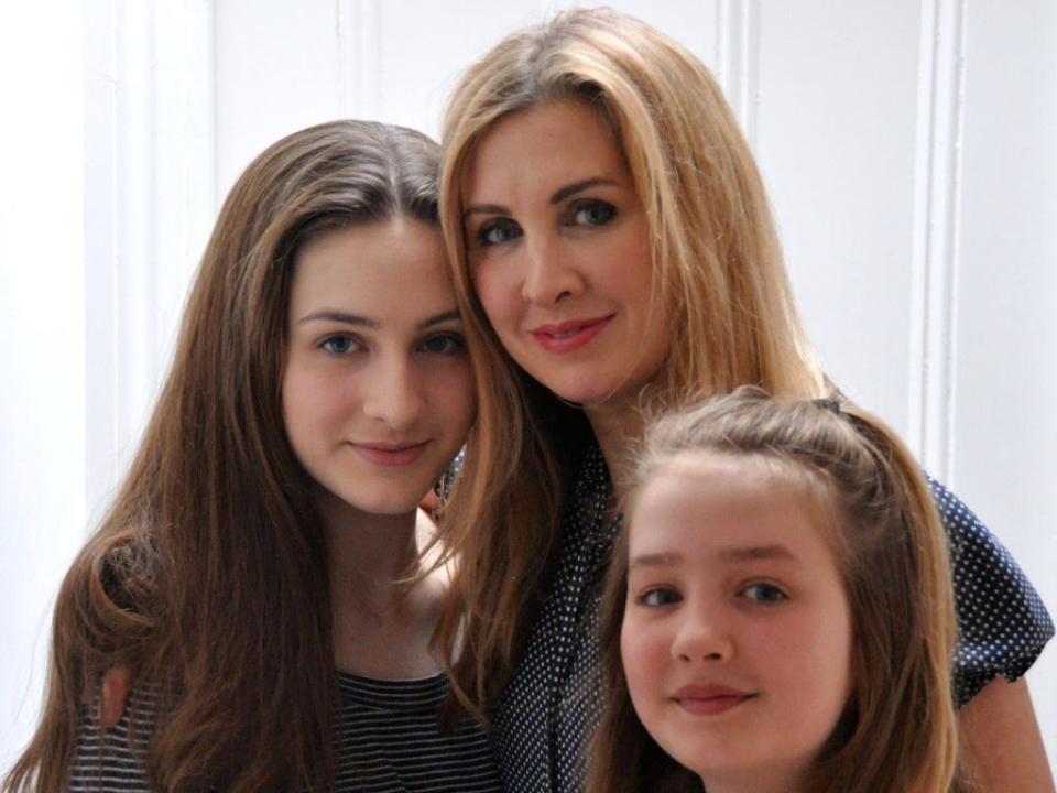 Tanith Carey and her daughters Lily, on the left, and Clio, on the right. Tanith stands with her arms both of them.