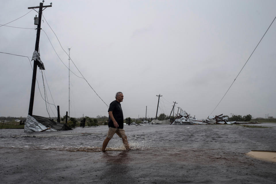 A man walks through floods waters after surveying his property, which was hit by Hurricane Harvey in Rockport, Texas. (Photo: Adrees Latif / Reuters)