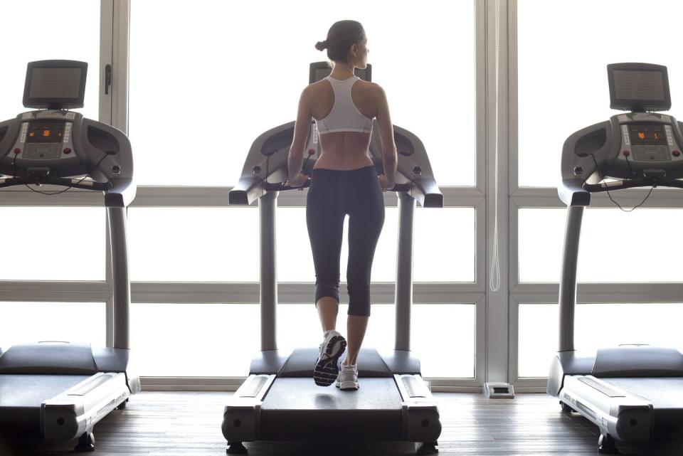woman jogging on treadmill at gym