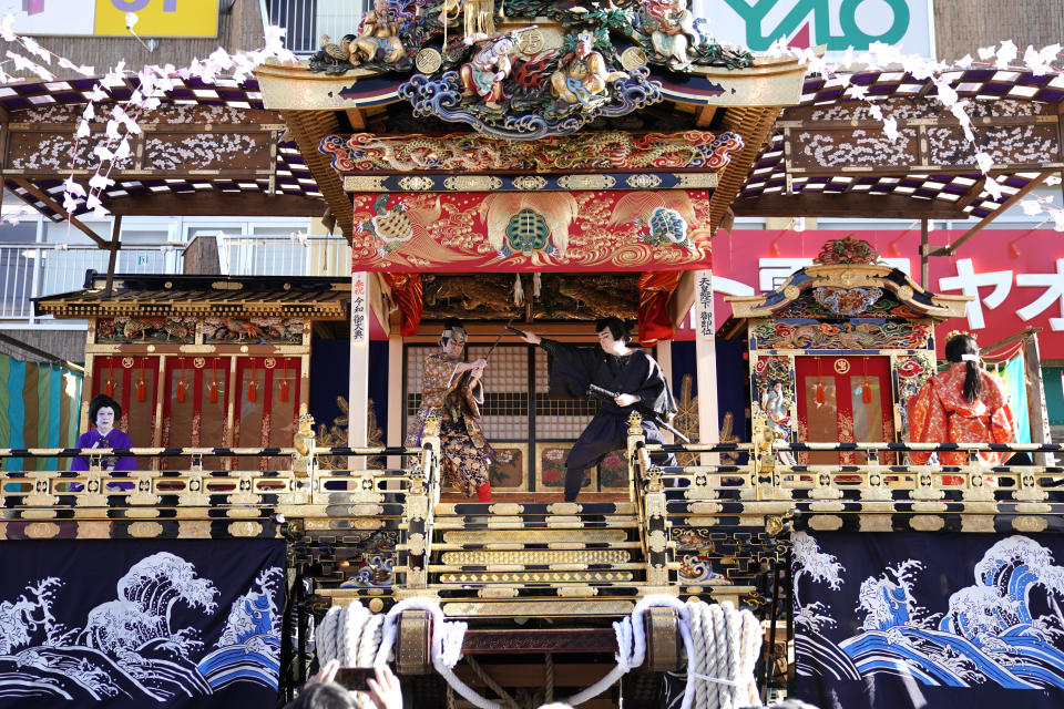 In this Tuesday, Dec. 3, 2019, photo, local residents perform kabuki inside a float for the Chichibu Night Festival in Chichibu, Japan. This two-day festival has its roots in an older tradition of villagers giving thanks to the nearby mountain god for helping them during the planting and harvesting season, according to the chief priest of the shrine. (AP Photo/Toru Hanai)
