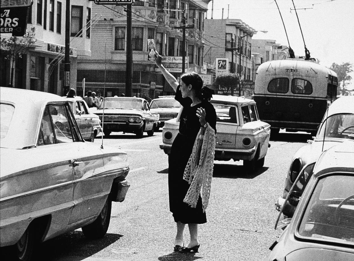 A hippie hands out flyers in San Francisco in 1967 - 2003 Getty Images