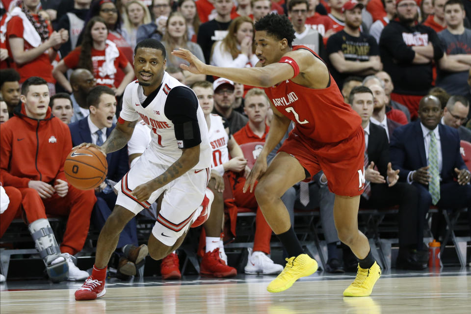 Ohio State's Luther Muhammad, left, brings the ball upcourt past Maryland's Aaron Wiggins during the second half of an NCAA college basketball game Sunday, Feb. 23, 2020, in Columbus, Ohio. (AP Photo/Jay LaPrete)