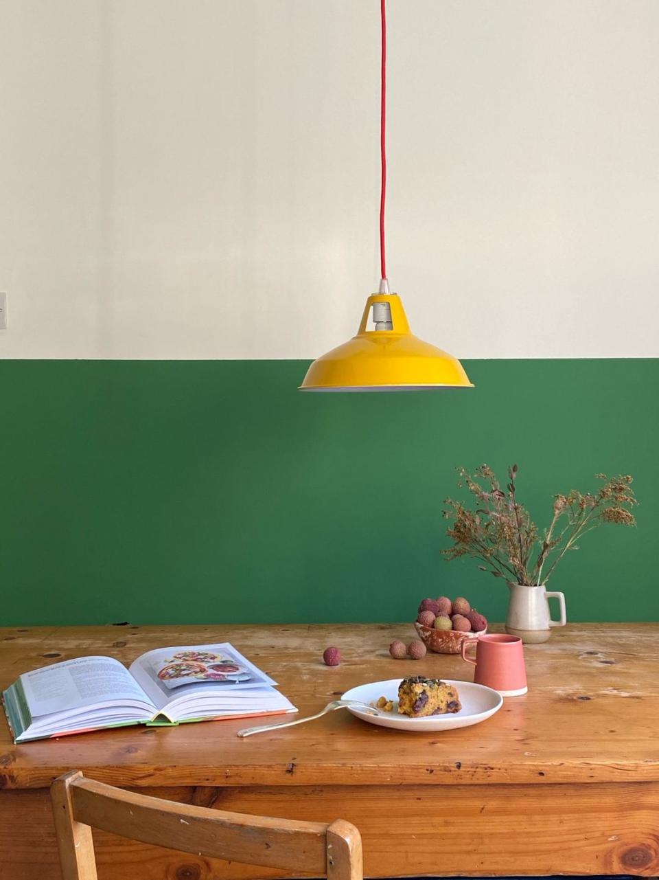 a table with a plate of food and a lamp