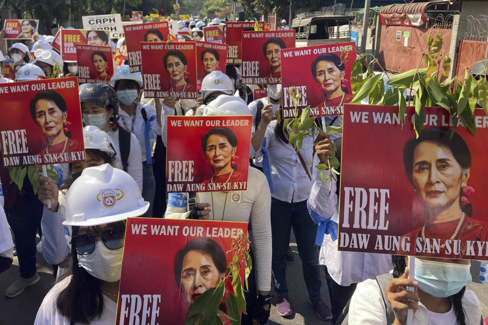 FILE - Protesters hold portraits of deposed Myanmar leader Aung San Suu Kyi during an anti-coup demonstration in Mandalay, Myanmar on March 5, 2021. Myanmar court on Monday, Dec. 6, 2021, sentenced ousted leader Suu Kyi to 4 years for incitement and breaking virus restrictions, then later in the day state TV announced that the country's military leader reduced the sentence by two years. (AP Photo/File)