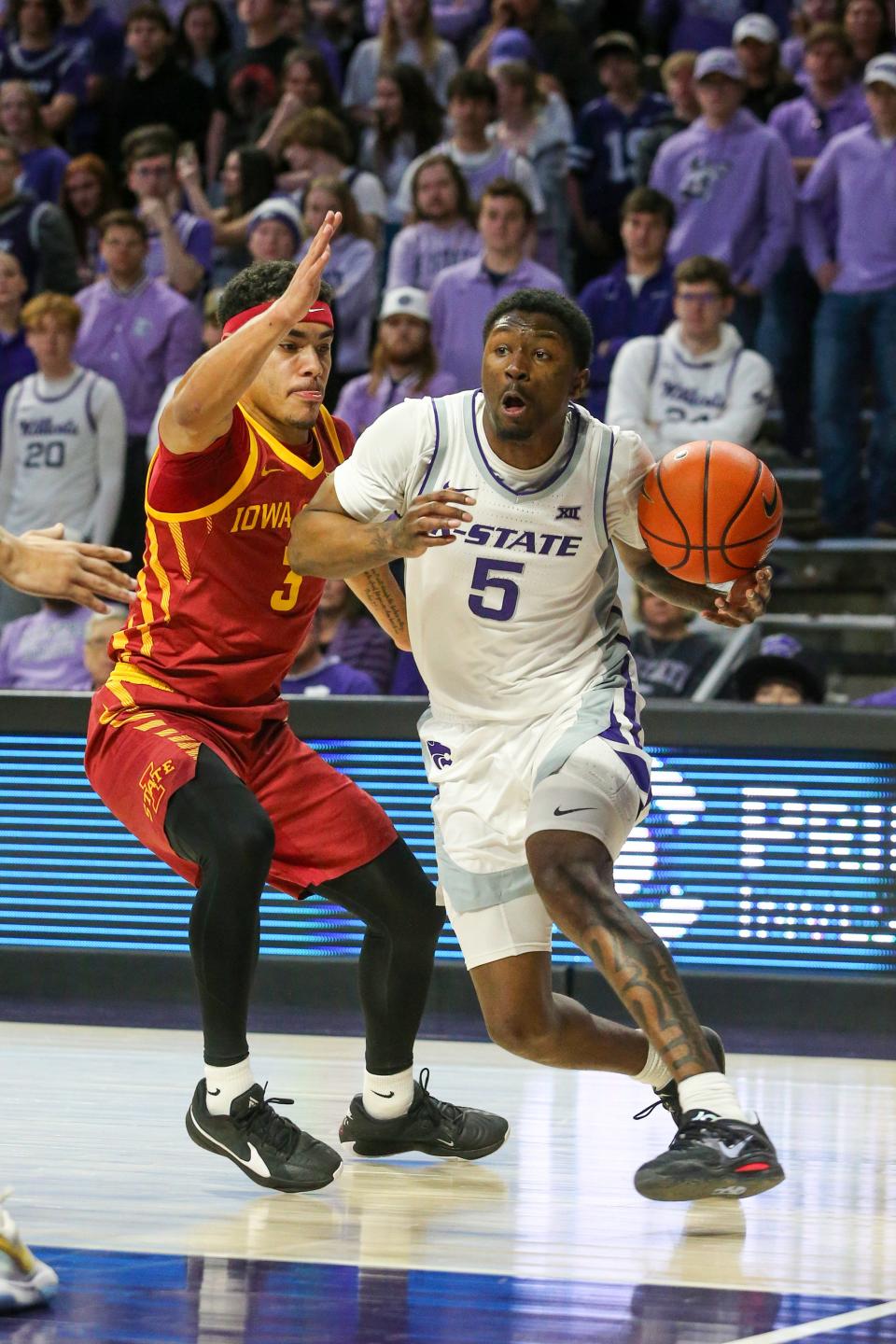 Kansas State guard Cam Carter (5) dribbles against Iowa State's Tamin Lipsey during  the regular-season finale March 9 at Bramlage Coliseum.