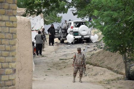 Soldiers and security officials guard a car after a bomb exploded next to a convoy of the deputy chairman of the Pakistan Senate, Senator Ghafoor Haideri, in Mastung, Pakistan May 12, 2017. REUTERS/Naseer Ahmed