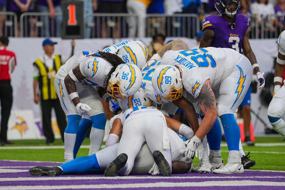 Sep 24, 2023; Minneapolis, Minnesota, USA; Los Angeles Chargers huddle around linebacker Kenneth Murray Jr. (9) after his interception against the Minnesota Vikings in the fourth quarter at U.S. Bank Stadium. Mandatory Credit: Brad Rempel-USA TODAY Sports