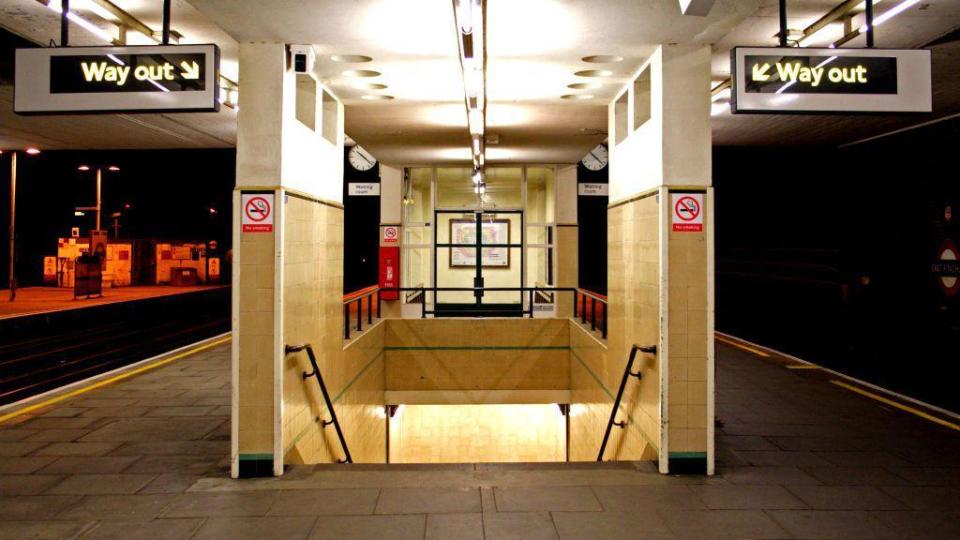 File image showing signs and an illuminated staircase at Finchley Road tube station
