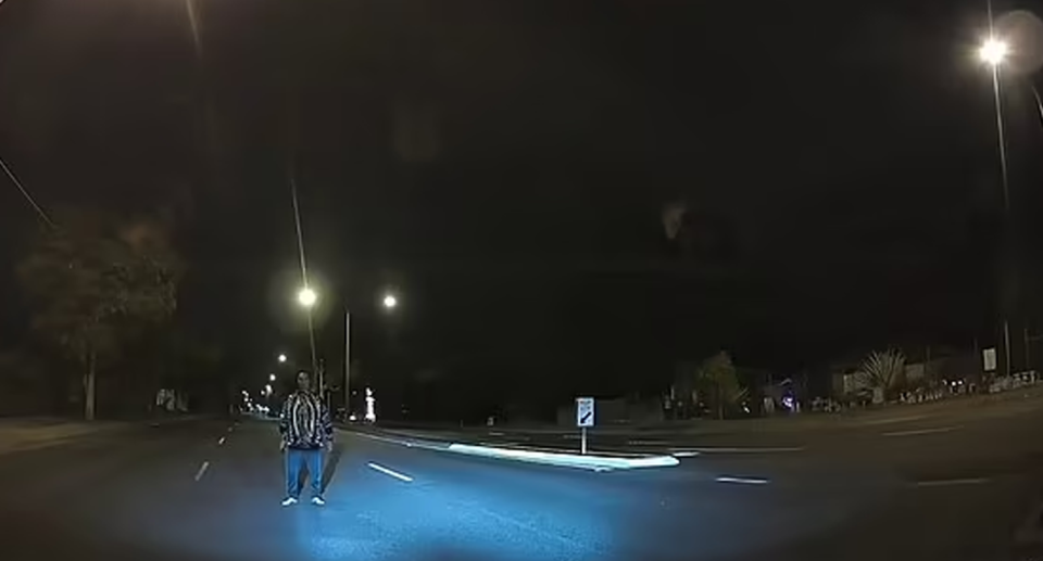 The Aussie driver's dashcam footage of the man standing in the middle of the street in Brisbane.