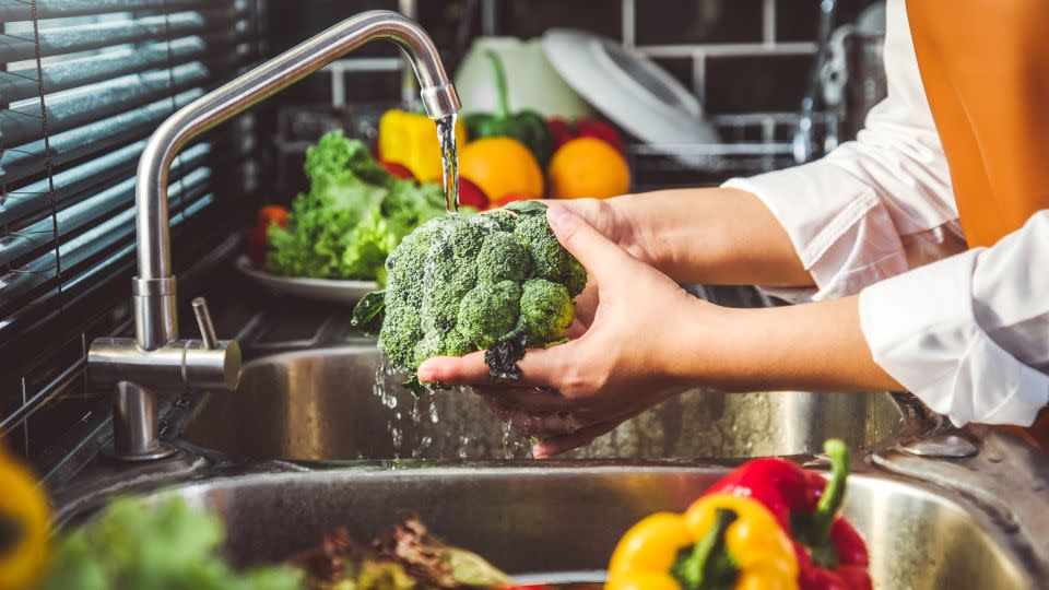 Washing vegetables and fruits under running water is one way to reduce the spread of foodborne illness, CNN wellness medical expert Dr. Leana Wen said. - Sarinyapinngam/iStockphoto/Getty Images