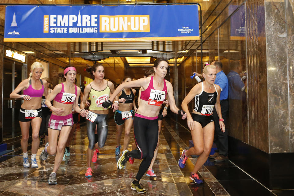 Australia's Suzy Walsham (110) and New Zealand's Melissa Moon (107) lead the women's division as they sprint for the stairs at the start of the Empire State Building Run-Up Wednesday, Feb. 5, 2014, in New York. Walsham won the race. (AP Photo/Jason DeCrow)