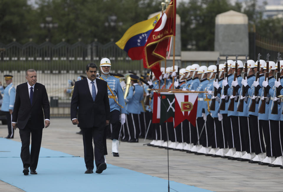 Turkish President Recep Tayyip Erdogan, left, and Venezuela's President Nicolas Maduro review a military honour guard during a welcome ceremony, in Ankara, Turkey, Wednesday, June 8, 2022.(AP Photo/Burhan Ozbilici)