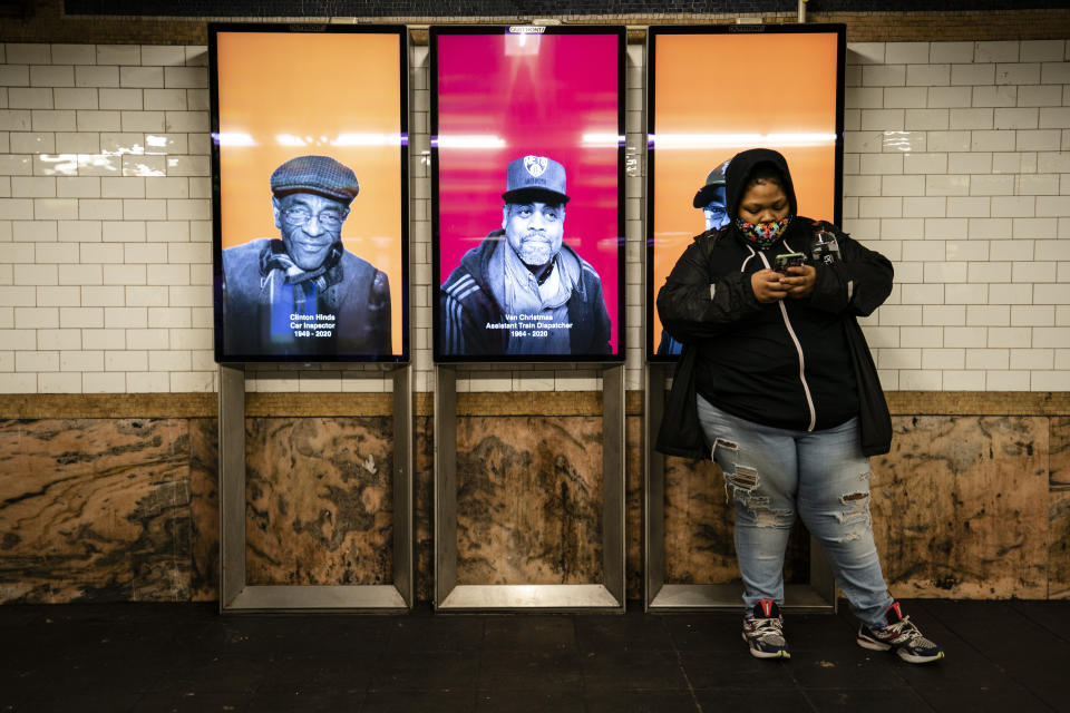 Faces of New York's Metropolitan Transportation Authority employees who died of COVID-19 are displayed at Fulton Street station, Monday, Jan. 25, 2021, in the Manhattan borough of New York. The MTA is honoring its 136 employees who have died from the virus since the pandemic began with a digital memorial at 107 subway stations. (AP Photo/John Minchillo)