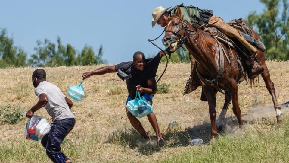 A U.S. Border Patrol agent on horseback on Sept. 19, 2021, tries to stop a Haitian migrant from entering an encampment on the banks of the Rio Grande near the Acuna Del Rio International Bridge in Del Rio, Texas. (Photo by PAUL RATJE/AFP via Getty Images)