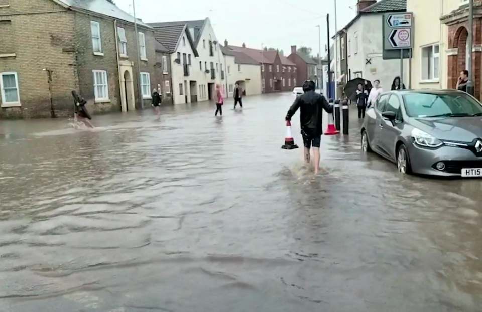 Residents wade through water in Market Rasen, Lincolnshire, after a torrential downpour.