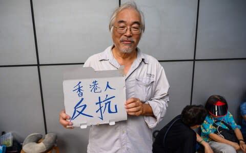 Alan Fung, 62, is taking part in a 48-hour sit-in outside the main police station on Hong Kong island - Credit: Michael Zhang