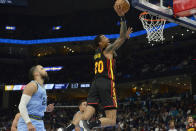 Atlanta Hawks forward John Collins (20) jumps to shoot ahead of Memphis Grizzlies forward Dillon Brooks (24) in the first half of an NBA basketball game Friday, Nov. 26, 2021, in Memphis, Tenn. (AP Photo/Brandon Dill)