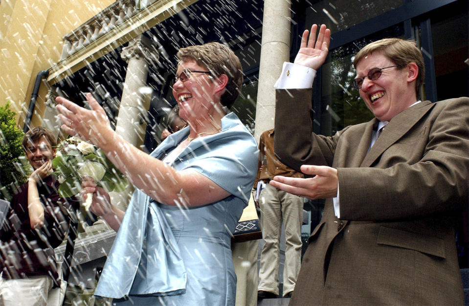 Belgians Marion Huibrechts, right, and Christel Verswyvelen leave the town hall of Kappelen, north Belgium, Friday, June 6, 2003. The two women became the first gay couple to marry in Belgium on Friday under laws passed earlier this year. Huibrechts and Verswyvelen celebrated 16 years of partnership with official vows at a civil ceremony. (AP Photo/Geert Vanden Wijngaert)