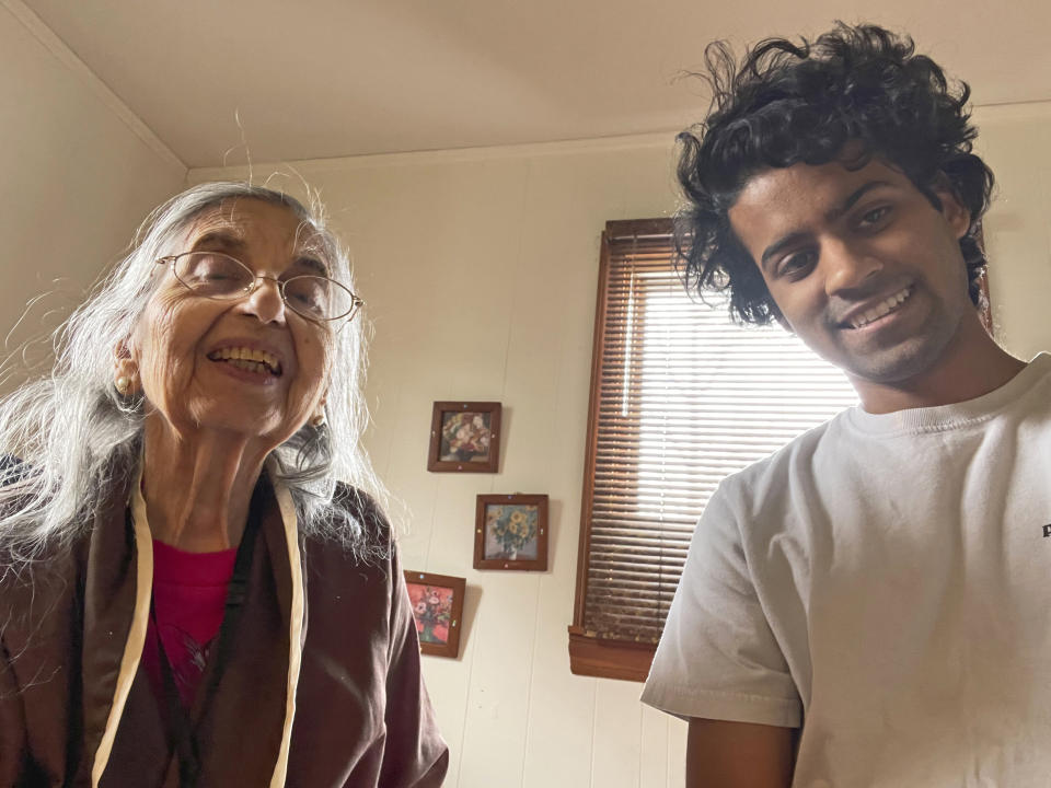 In this photo provided by courtesy of Arman Ramnath, Arman poses with his grandmother, Vijaya Ramnath, Feb. 14, 2021, in Columbus, Ohio. Ramanth, 27, has been nervous about getting near his older grandmother, Vijaya, during the coronavirus pandemic, especially whenever he has just returned from Washington, where he is a Georgetown University Law School student. He is studying remotely but sometimes must visit school such as to pick up books. (Arman Ramnath via AP)