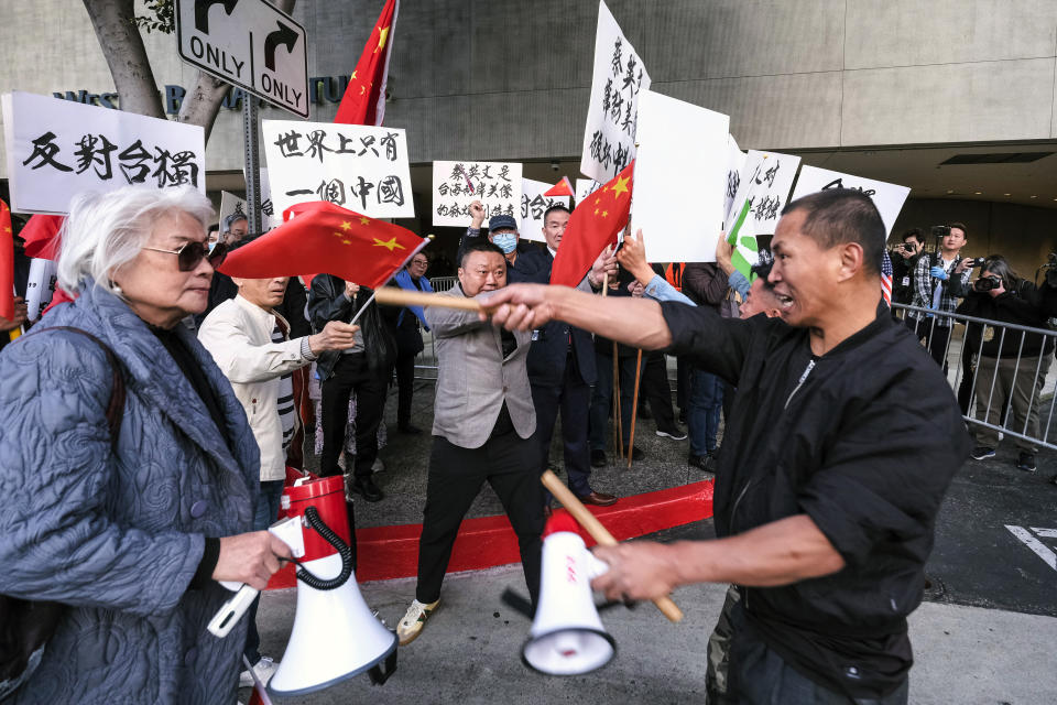 A supporter of Taiwan, right, confronts protesters opposed to Taiwanese independence outside a hotel where Taiwanese President Tsai Ing-wen is expected to arrive in Los Angeles, Tuesday, April 4, 2023. (AP Photo/Ringo H.W. Chiu)