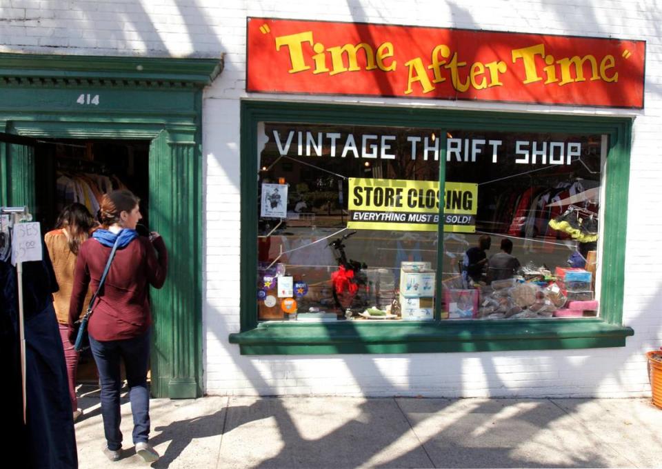 Passerby Elisabeth Albert of Durham, left, checks out the front window as the walks in to the Time After Time vintage thrift shop in the 400 block of W. Franklin St., Friday, March 21, 2014. Store owners Annie Jackson and husband Steven Schrenzel closed their well known store on April 15, 2014 after more than 30 years in business to pursue travel and other plans.