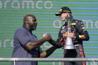 Red Bull driver Max Verstappen, right, of the Netherlands, is congratulated by Shaquille O'Neal after winning the Formula One U.S. Grand Prix auto race at Circuit of the Americas, Sunday, Oct. 24, 2021, in Austin, Texas. (AP Photo/Darron Cummings)