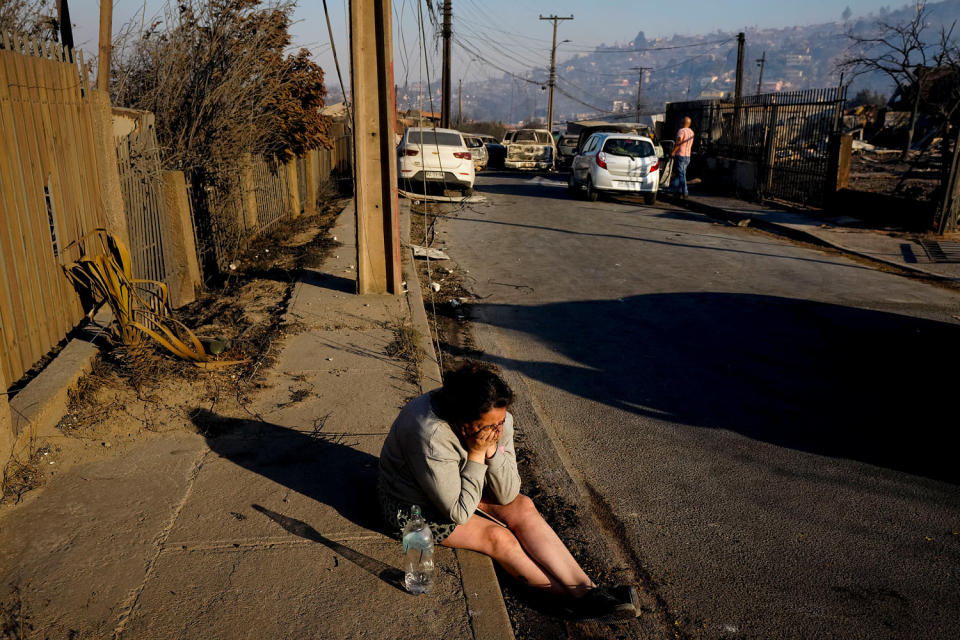 A woman cries after a friend died in the wildfire. (Esteban Felix / AP)