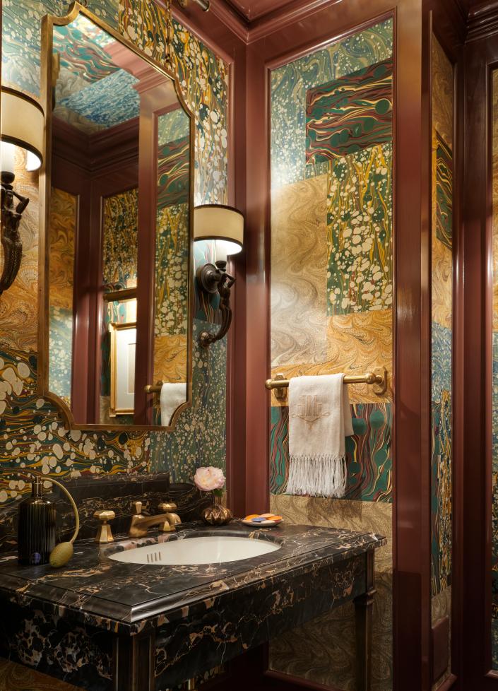 In this bathroom designed by Jessica Lagrange Interiors, rich colors and complex materiality embrace Deco-era decadence.