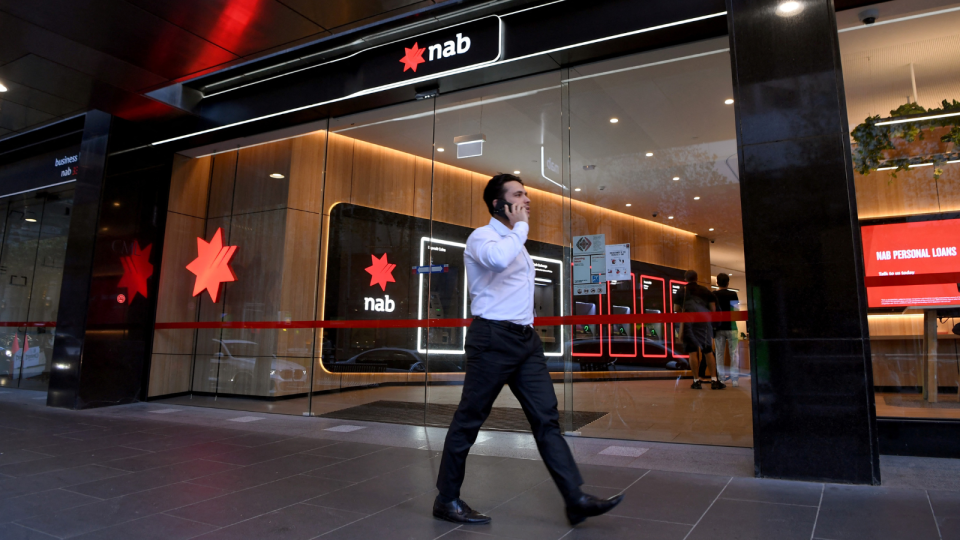 NAB branch with person walking outside.