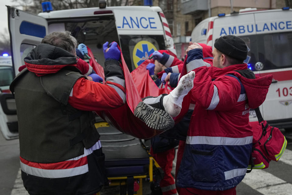 Rescuers evacuate a wounded man after a Russian attack in Kyiv, Ukraine, Tuesday, Jan. 23, 2024. (AP Photo/Efrem Lukatsky)