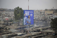 A billboard asking Kenyans to vote for Kenyan presidential candidate Raila Odinga, referred to affectionately as "Baba", the Swahili word for "father", and his running mate Martha Karua, rises above shacks in the low-income Mathare neighborhood of Nairobi, Kenya Friday, July 29, 2022. Kenya's Aug. 9 election is ripping open the scars of inequality and corruption as East Africa's economic hub chooses a successor to President Uhuru Kenyatta. (AP Photo/Brian Inganga)