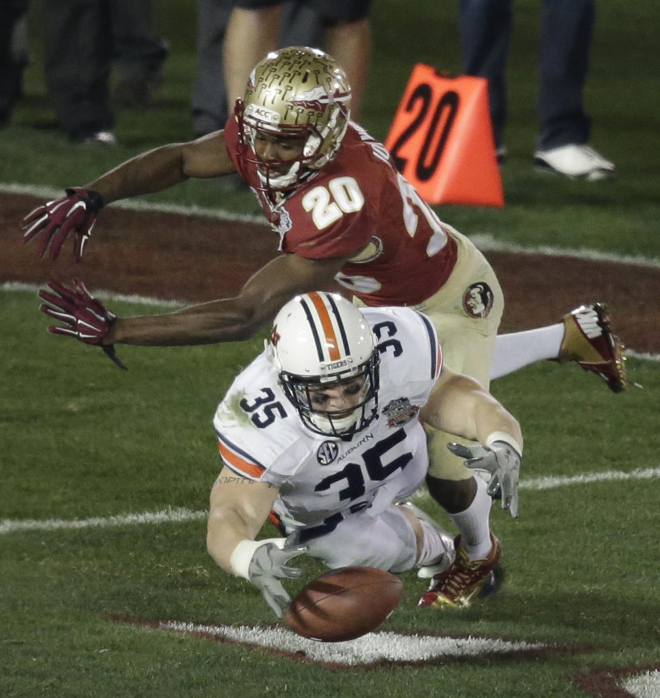 Auburn's Jay Prosch fumbles a kickoff with Florida State's Lamarcus Joyner (20) defending during the second half of the NCAA BCS National Championship college football game Monday, Jan. 6, 2014, in Pasadena, Calif. Auburn rrecovered the ball(AP Photo/Gregory Bull)