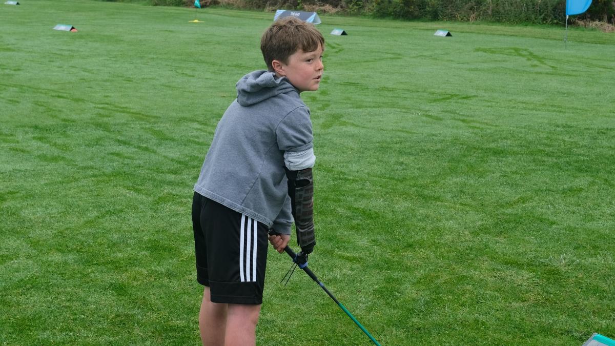 Boy with limb difference ‘excited’ to play golf with grandfather thanks to tool