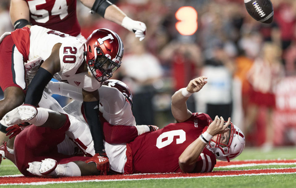 Nebraska quarterback Chubba Purdy, right, fumbles the ball in the Indiana end zone while being tackled by Indiana's Louis Moore (20) and Cam Jones during the first half of an NCAA college football game Saturday, Oct. 1, 2022, in Lincoln, Neb. Moore recovered the ball for a touchdown. (AP Photo/Rebecca S. Gratz)